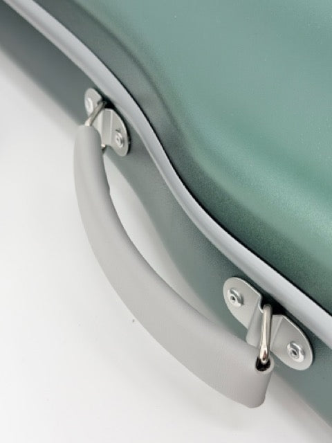 Close-up of the gray handle on the Artino Muse CN3804 Violin Case (4/4 & 3/4), showcasing its sturdy metal hardware and the smooth, matte green polycarbonate hard-shell surface.