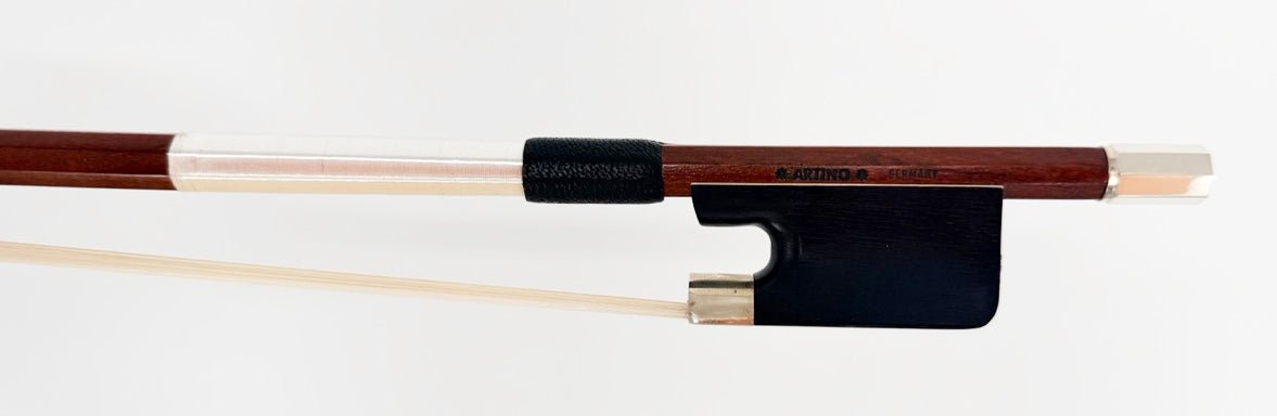 A close-up of the Artino Germany BF-315A Pernambuco Cello Bow – Octagonal highlights the refined German craftsmanship, showcasing its octagonal pernambuco wooden stick, black frog with silver fittings, and light-colored horsehair—all set against a plain white background.
