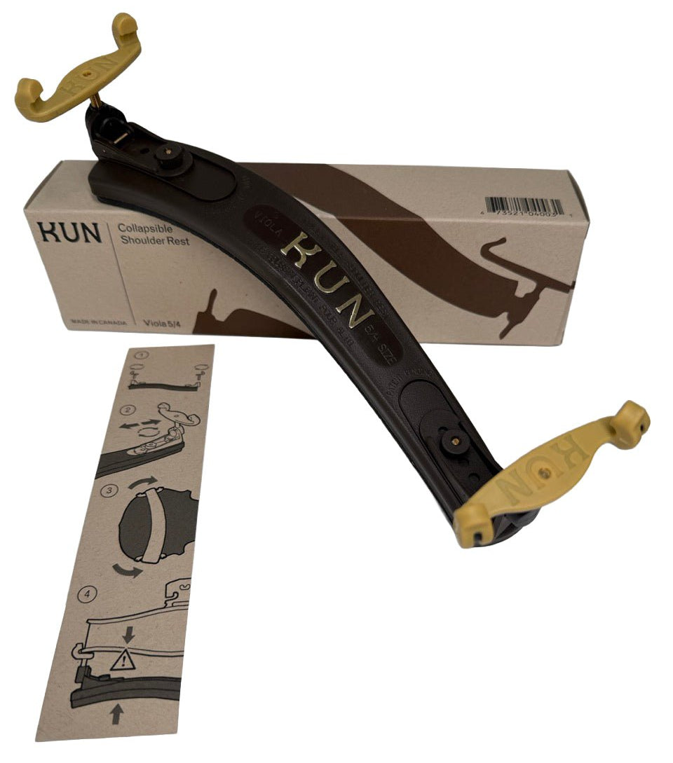 A KUN Original Viola Shoulder Rest 15-17" | Adjustable in black and gold, labeled KUN, rests atop its box with an instruction sheet showing assembly steps placed beside them.