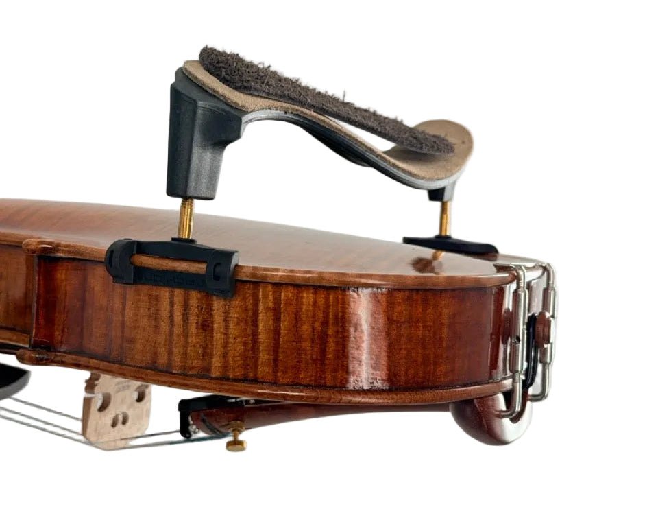 Close-up of a violin’s back fitted with the Mach One MLS Shoulder Rest with Leather Strap (Plastic), featuring black and gold supports, alongside some instrument hardware, isolated on a white background. Suitable for 4/4–3/4 violins.