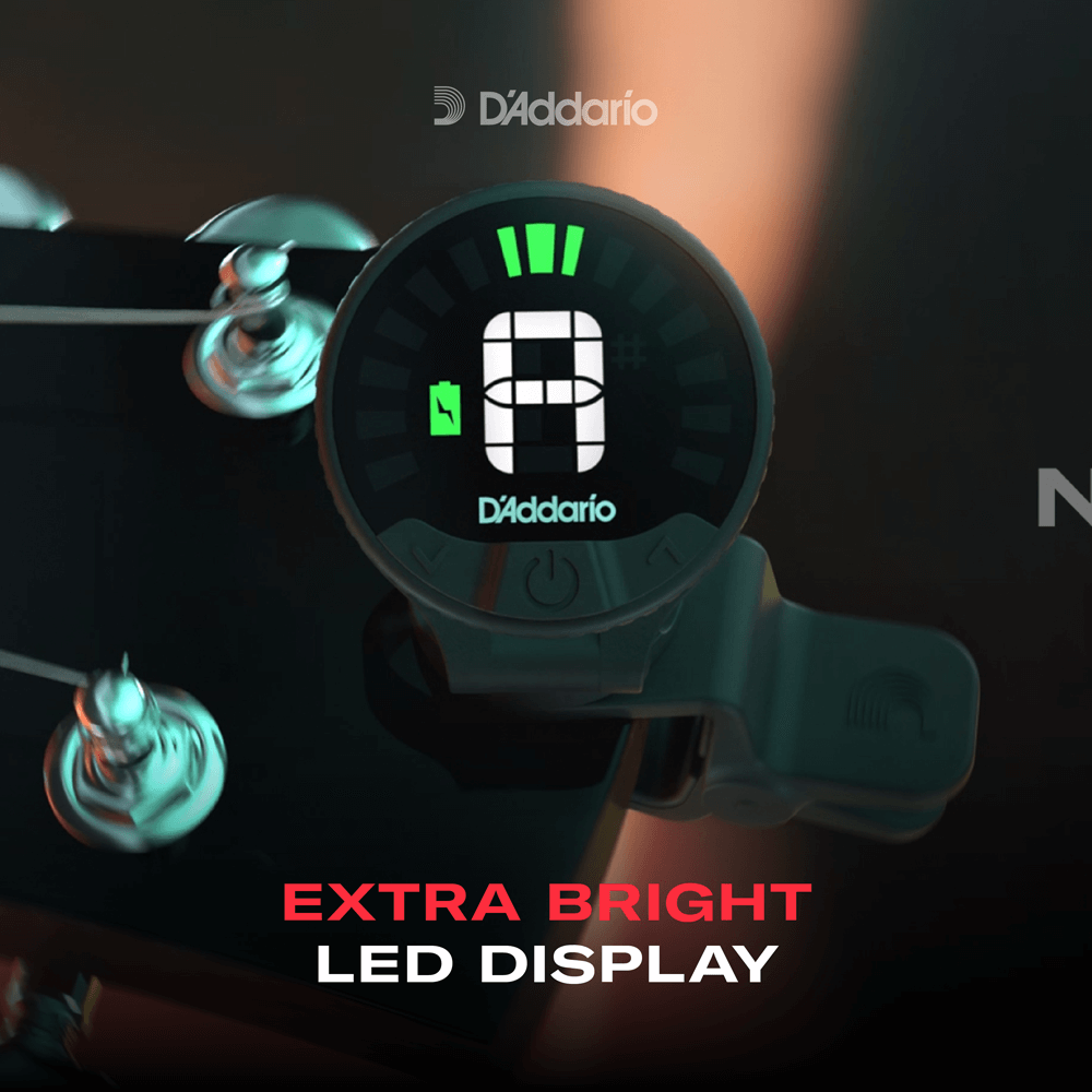 A violin headstock with a Nexxus 360 Violin Rechargeable Tuner clipped on, featuring an extra bright 360-degree LED display with tuning bars and a battery icon. Text below reads: Extra Bright LED Display.