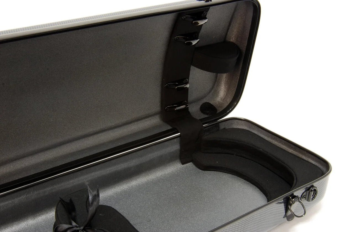 The Otto Musica Mirage CN-512 Oblong Violin Case is displayed open and empty, featuring a textured carbon-hybrid exterior, shaped interior padding, black straps, and an accessory compartment. This lightweight case rests on a flat surface with its lid fully open.