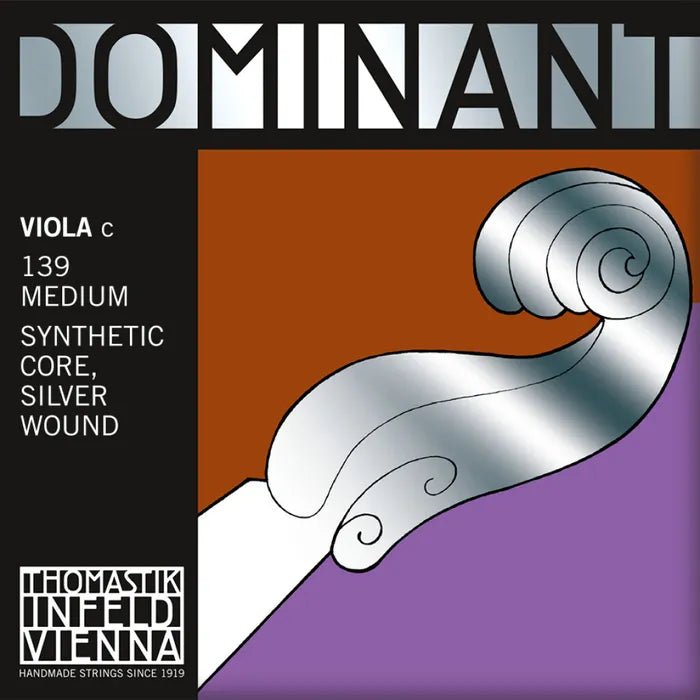The Thomastik Dominant Viola C String packaging showcases a bold silver scroll design set against a black and orange background, with clear text indicating "VIOLA C," "139 MEDIUM," "PERLON SYNTHETIC CORE," and "SILVER WOUND." The product's branding, Thomastik Dominant Viola C String, is prominently displayed at the bottom.