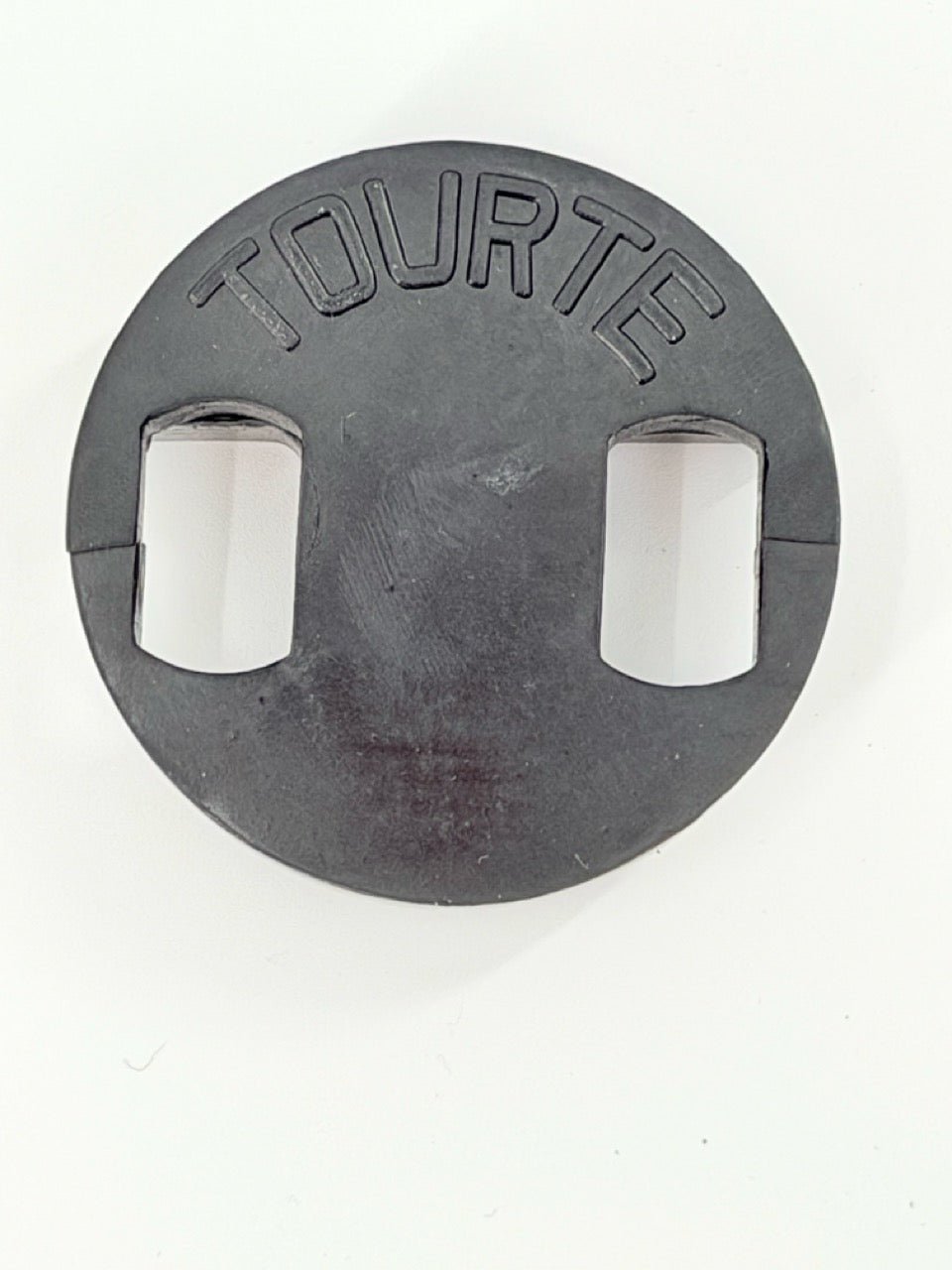 The Tourte Bass Mute is a round, black rubber mute with two rectangular cutouts and "TOURTE" embossed on top, designed for double bass players who prefer a classic Tourte mute style.