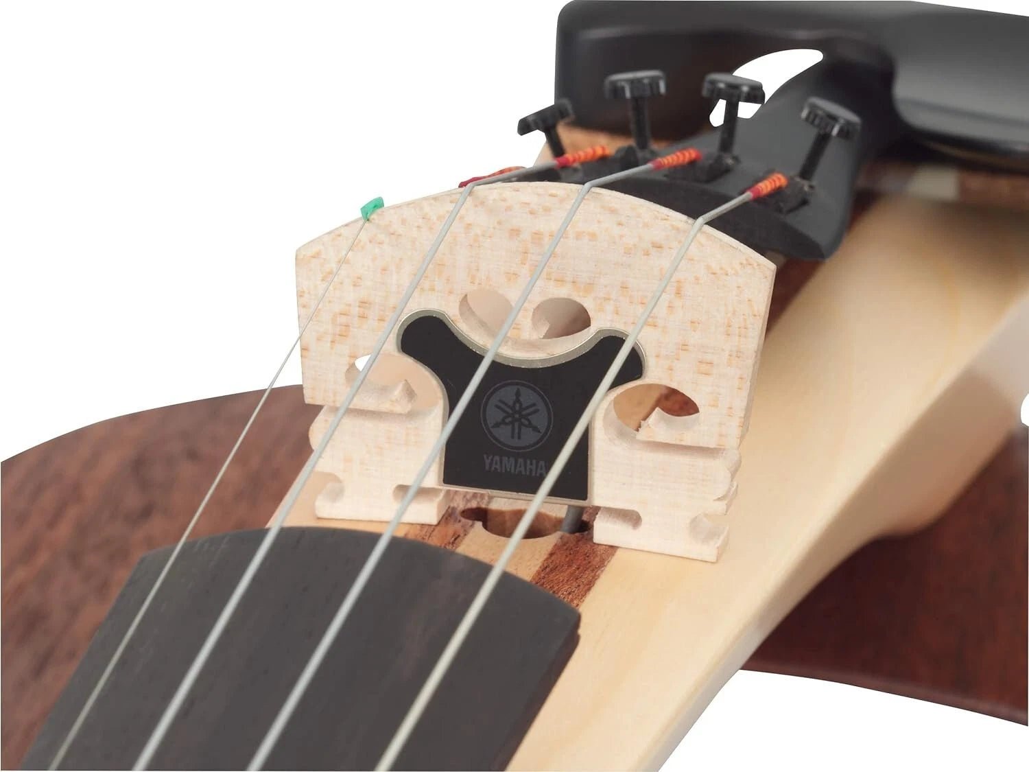 Close-up of the Yamaha YEV104NT Natural Electric Violin’s bridge, highlighting its strings, fine tuners, wooden body details, and passive bridge pickup. The Yamaha logo is visible on the black section beneath the bridge.