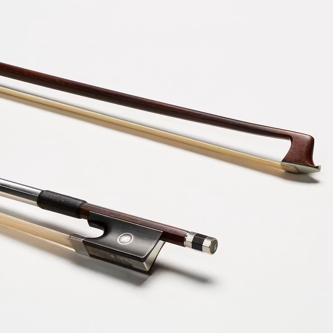 Two violin bows appear on a white background. The top bow is horizontal, while the diagonally placed Eastman BL50 Brazilwood Violin Bow - 4/4 below shows its frog and screw—perfect for advanced players seeking quality and durability.