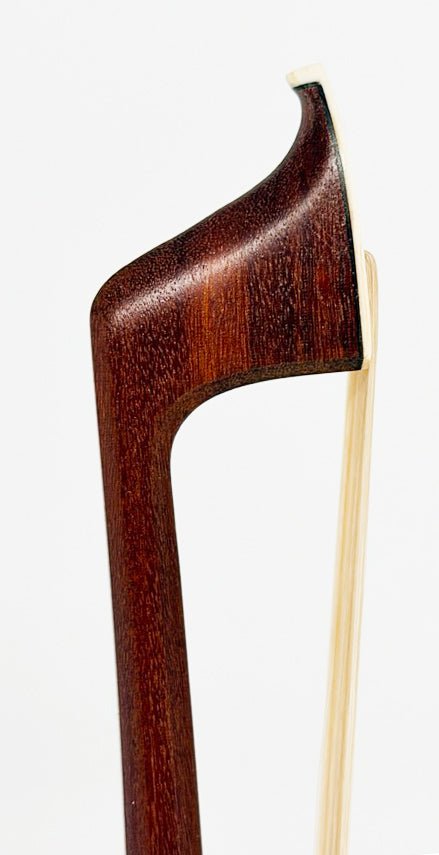 Close-up of the tip of the Artino Germany BF-315A Pernambuco Cello Bow – Octagonal against a white background, highlighting its intricately curved shape and smooth, dark wood finish—a testament to traditional German bow-making craftsmanship.