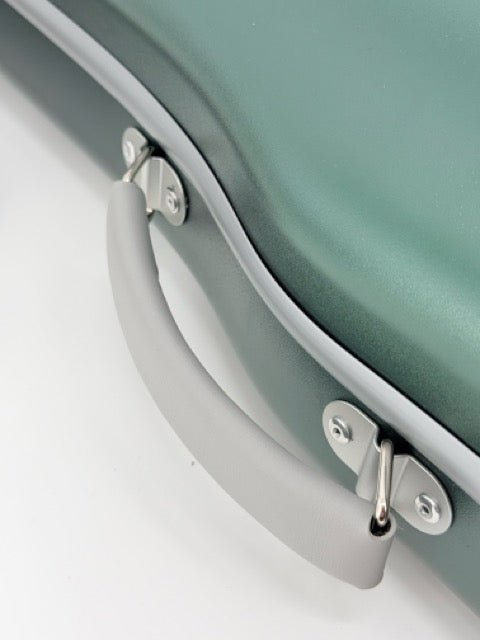 Close-up of the gray handle on the Artino Muse CN3804 Violin Case (4/4 & 3/4), showcasing its sturdy metal hardware and the smooth, matte green polycarbonate hard-shell surface.