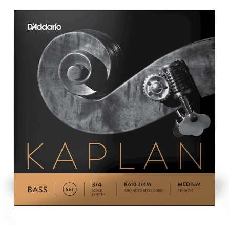 Close-up of a double bass scroll and tuning peg on a D’Addario Kaplan Bass A String Medium Tension box. Text notes 3/4 scale, stranded steel core for stable intonation and warm, centered tone. Packaging features black and bronze design.