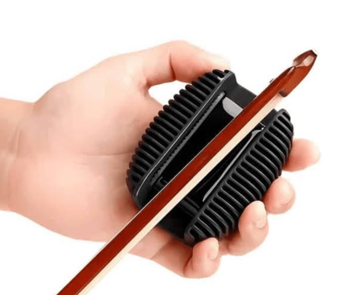A hand holds the D’Addario Rosin Guard with Natural Dark Rosin, a refillable rosin holder, while a violin bow is drawn through it against a white background.