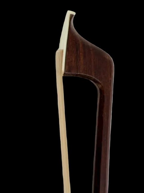 Close-up view of the tip of a G. Werner Octagonal Pernambuco Cello Bow, highlighting its curved wooden structure and light-colored bow hair set against a black background.