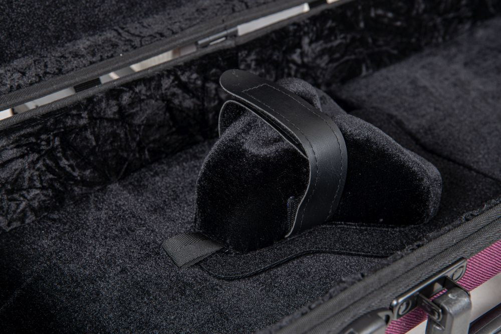 Close-up of an open, empty black velvet-lined instrument case featuring a padded support and a central securing strap, reminiscent of the GEWA Bio-A Oblong Violin Case – Violet | Adjustable 1/2 to 4/4—an eco-friendly and thoughtfully designed violin case that offers sustainable materials and reliable protection.