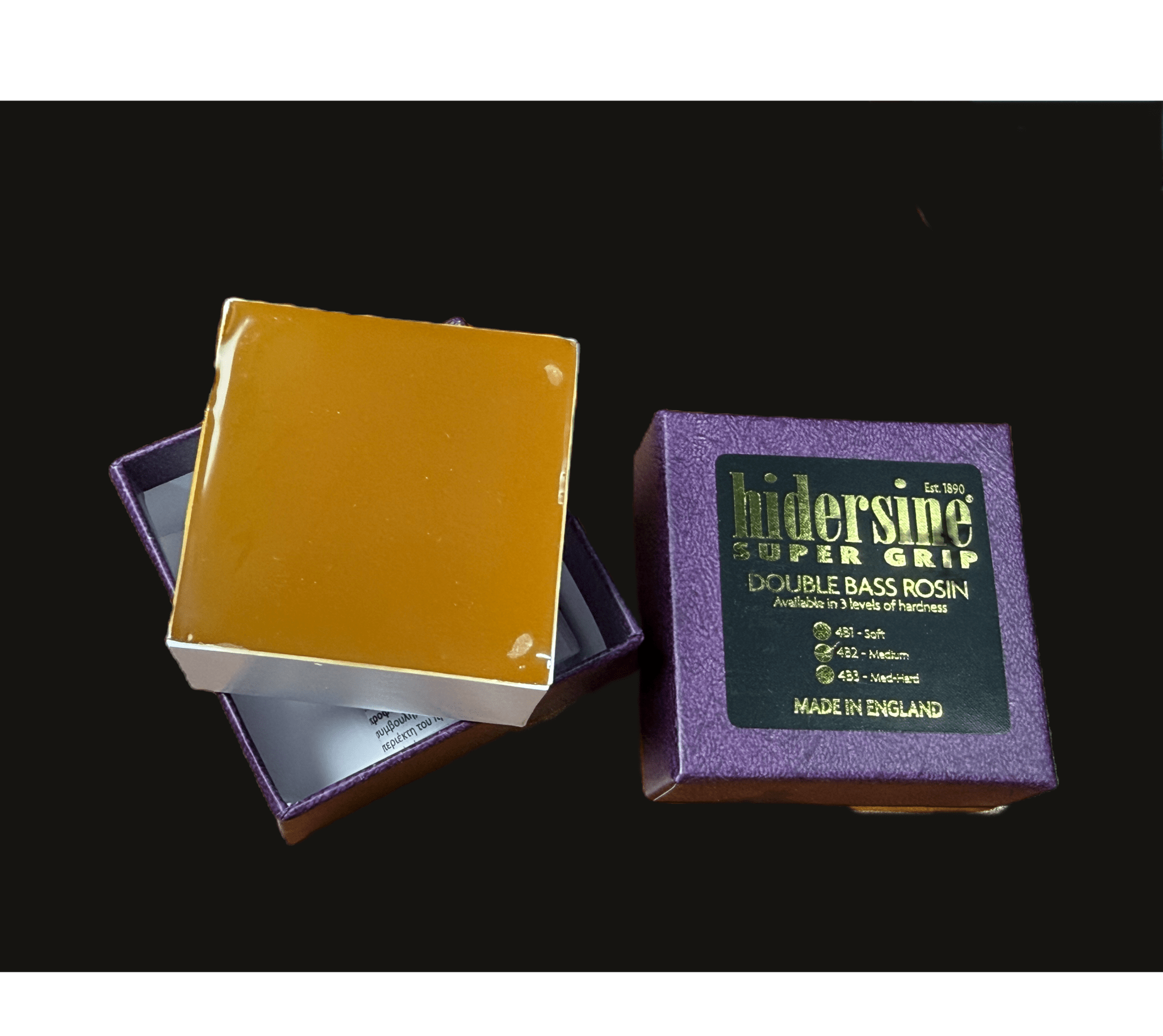 A box of Hidersine Medium Bass Rosin, with the lid off showing amber rosin inside. The purple box has a gold and black label indicating it is made in England.