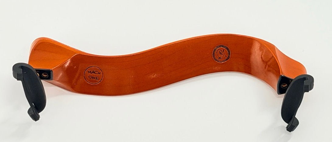 The Mach One MA Maple Shoulder Rest – Premium Wooden Violin Support (4/4–3/4) features a curved maple design, orange-brown finish, black rubber feet, and stamped brand markings for ergonomic violin support.