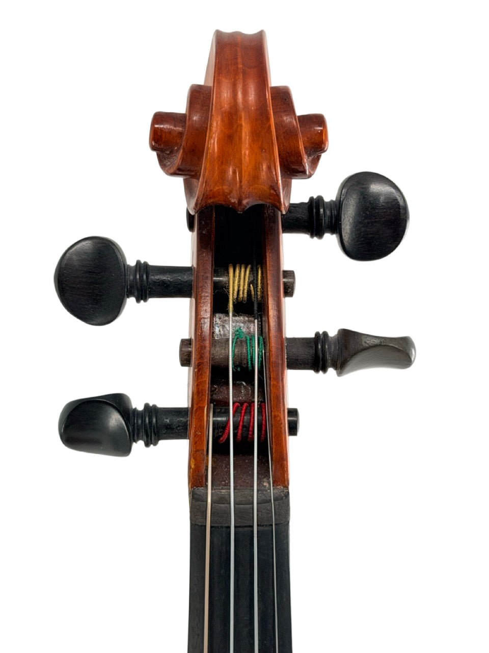 Close-up view of the scroll and tuning pegs of the Octav Mures Romanian Intermediate Violin — Professionally Set Up by Atelier, with visible strings and fine wood grain details highlighting quality craftsmanship.