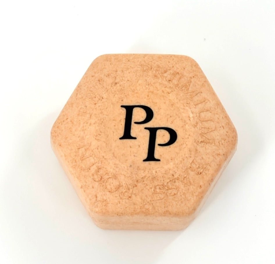 A hexagonal, light brown block of Petz Premium Bass Rosin with "PP" in black on top and faint circular embossed text, shown on a white background.