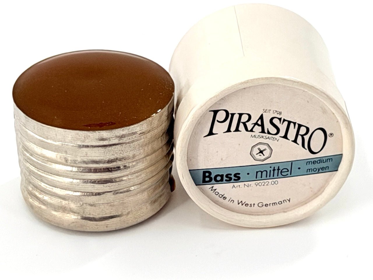 A container of Pirastro Bass Rosin – Medium with its lid off, showing the brown rosin cake next to the white container labeled Pirastro Bass Rosin – Medium.