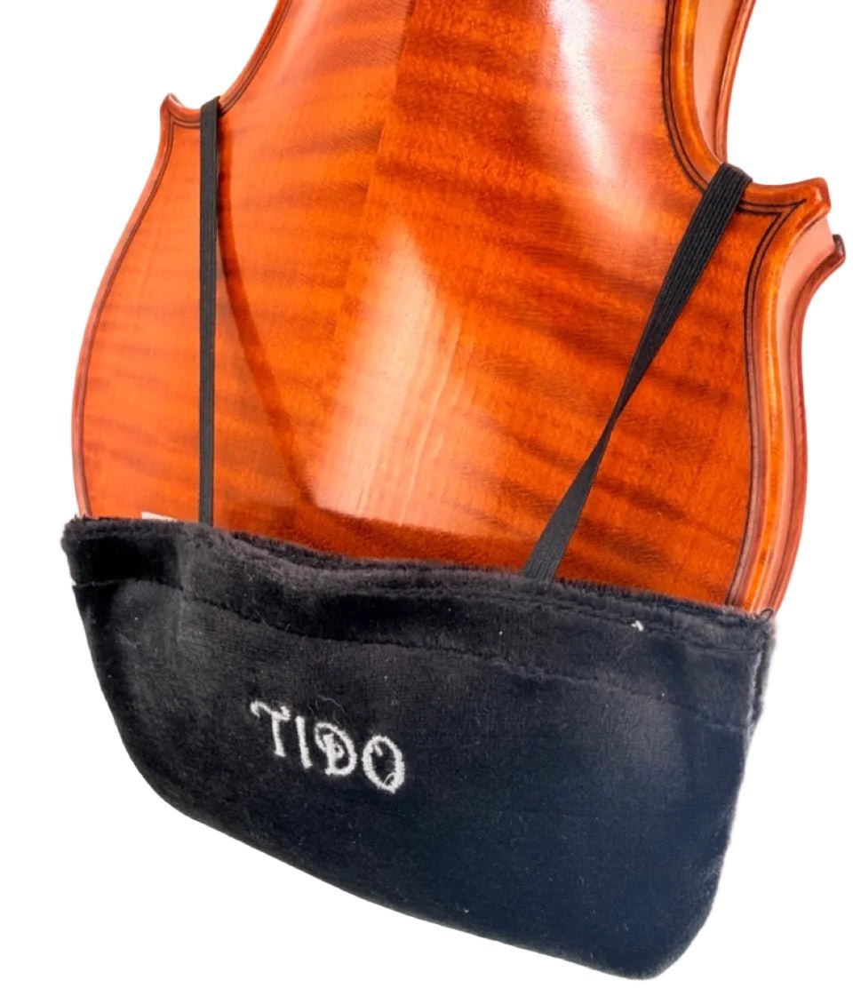 The Tido Universal Chinrest & Shoulder Pad for Violin and Viola is a soft black pouch labeled TIDO, attached with elastic bands to the back of your instrument to catch rosin dust or provide cushioning, similar to a viola chinrest pad.