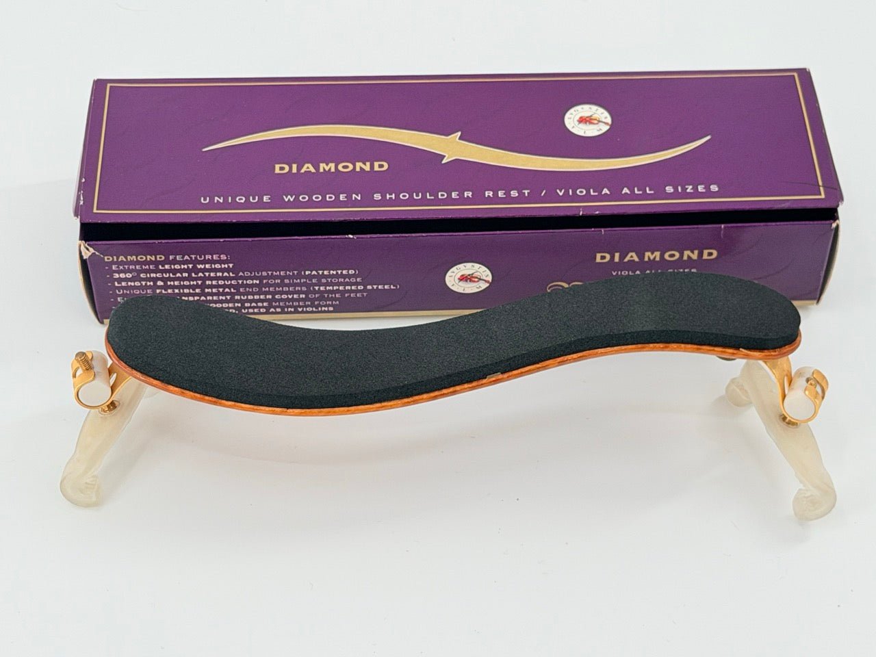 The Viva La Musica Diamond Shoulder Rest, a European-made wooden viola rest with black padding and adjustable feet, is shown in front of a purple Diamond Unique Wooden Shoulder Rest / Viola All Sizes box.