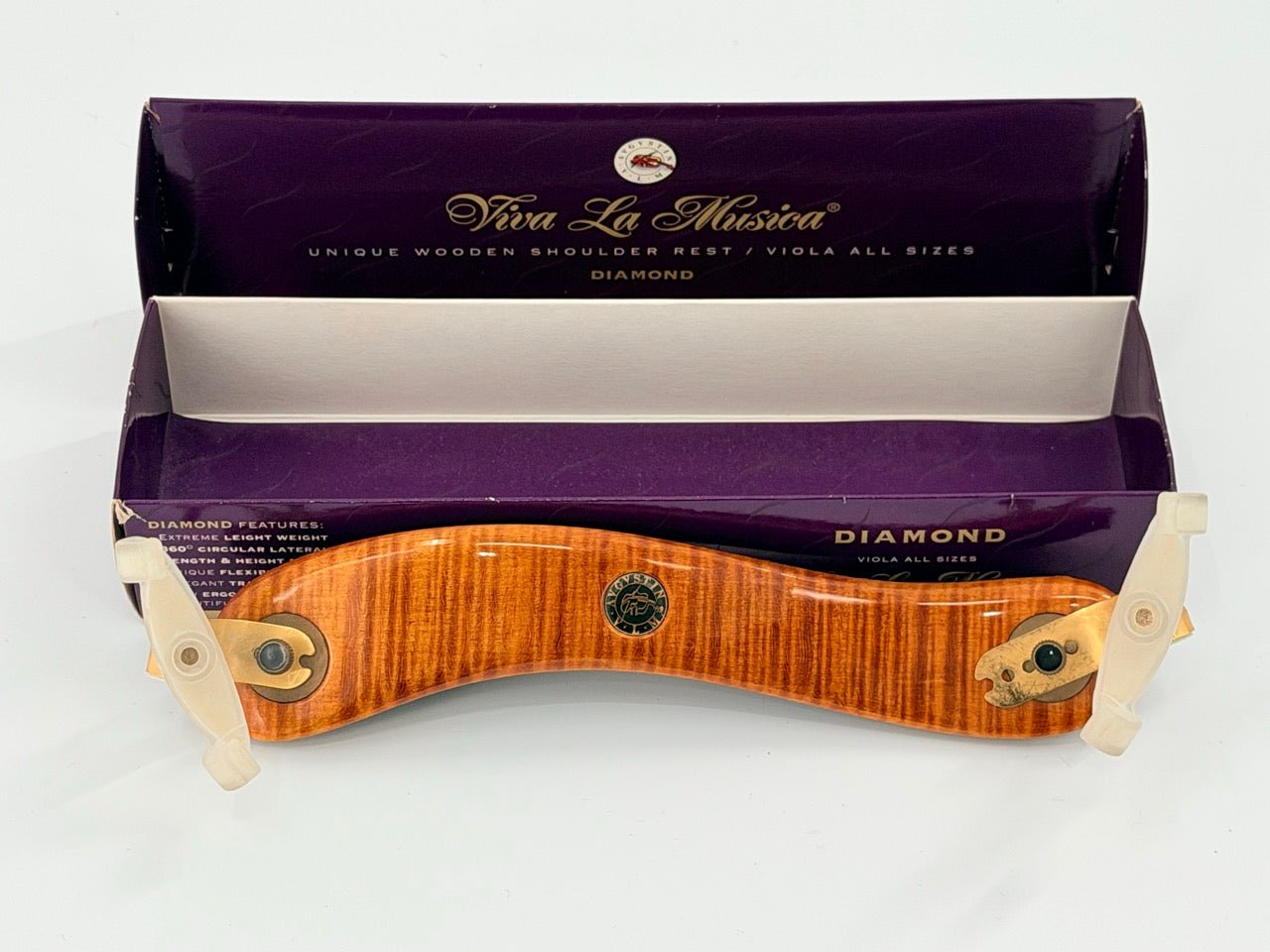 A Viva La Musica Diamond Shoulder Rest for viola is shown before its purple and cream box, featuring a curved, polished wood design with adjustable white end brackets.